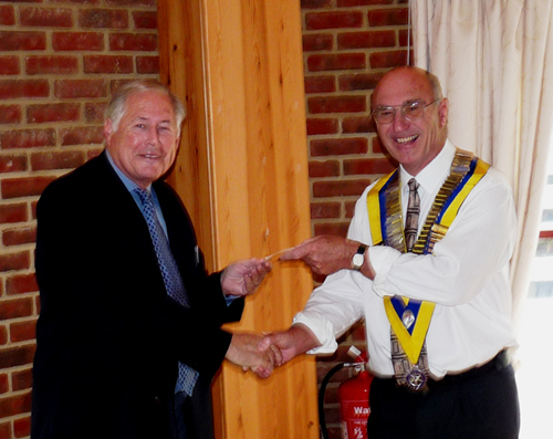 Caterham Rotary President, David Mole (right) presents the cheque to Rotary International Committee Chairman Rod Stead. 